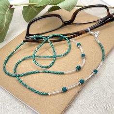 Sparkly eyeglass necklace chain made with Preciosa Czech crystal seed beads in green tones with delicate light green and blue flashes and small, green Lava Stone gems. Unique and bohemian this necklace chain will definitely create a unique look. Paired with beautiful silver plated crystal seed beads, this handmade eyeglass chain will definitely create a unique look. This eyeglass lanyard is made on strong quality beading wire with silver plated wire guardians that protect the quality eyeglass ho Adjustable Glass Gemstone Beads, Green Beaded Glass Jewelry, Green Glass Beaded Jewelry, Adjustable Glass Beaded Necklace With Gemstone Beads, Adjustable Glass Gemstone Beaded Necklaces, Adjustable Glass Gemstone Beaded Necklace, Green Glass Gemstone Bead Jewelry, Green Glass Jewelry With Gemstone Beads, Green Glass Gemstone Beads Jewelry