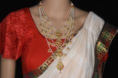 About the Jewellery  From fashion to jewelry, a resurgence of heritage styles is ruling bridal fashion right now, and nothing spells a royal bride more than these ornate layered necklaces. A symbol of nobility in the Deccan in ancient times, Panchladas (5-strand) and Satladas (7-strand) are regal necklaces crafted from pearls,  and other gemstones. This vintage style rani-haar's return to popularity can be credited to designer Sabyasachi Mukherjee. Today, these bold, yet classy necklaces can mak Traditional Pearl Necklace With Intricate Design For Receptions, Kundan Bridal Necklace With Motifs For Wedding, Chandbali Bridal Necklace With Motifs, White Motif Necklaces For Weddings, Traditional Gold Pearl Necklace For Marriage, Elegant Temple Necklace For Diwali Marriage, Elegant Temple Necklace For Marriage And Diwali, Traditional Bridal Necklace For Festive Season, White Temple Necklace With Zari Work For Wedding