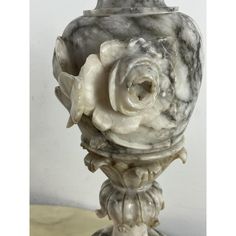 a white marble vase sitting on top of a table