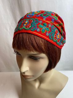 "Charming cotton embroidered cap. It has a timeless old world feel. The colors are bright & bold. I'm not sure of its era, it has no labels or indicators of when it was made. Possibly hand made by someone?  I will say, it has a timeless style.  It has a little covered elastic band in the back which keeps it snug on your head. My feeling it will fit best on a small to average size head.  It is not lined inside. It has a home made quality. No flaws noted.  This is hard to measure honestly, but I w Cotton Beanie Hat With Sweatband, Cotton Beanie With Sweatband, Cotton Beanie With Cotton Sweatband, Bohemian Beanie Headwrap, Festival Bandana Headband, One Size Fits Most, Casual Beanie-style Turban, One Size, Hippie Festival Headwrap One Size, Festival Bandana Headband One Size Fits Most, Casual Beanie Turban, One Size Fits Most