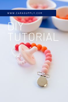 the diy beaded pacifier bracelet is displayed on a table