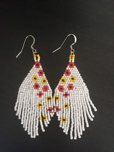 White, yellow, red and black beads. Measures 3 in long by 1 1/4 wide.  fishhook stainless steel ear wires. White Dangle Earrings With Fish Hook, White Drop Earrings With Fish Hooks, Traditional White Earrings With Ear Wire, White Jewelry With Dangling Beads In Distinctive Style, Unique White Jewelry With Dangling Beads, Unique White Teardrop Beaded Earrings, White Fish Hook Earrings As Gift, Traditional White Beaded Earrings With Ear Wire, Earrings Patterns