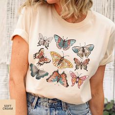 Pretty shirt for butterfly/nature/garden lovers! - Choose color from drop-down menu. - Unisex sizing. Please reference size chart, keeping in mind that the sizing table only contains measurements for one side of the garment, not the circumference. Choose size from drop-down menu. - Please allow 7-10 business days for processing and shipping. -Bella and Canvas Tees are a buttery-soft cotton/cotton blend shirt with rib-knit collars and sloped shoulders to bolster shaping. Our designs are printed with water-based, non-toxic, odorless ink. - Care Instructions Items should be washed inside out in cold water without bleach, dry cleaning, or ironing directly on the pattern. - Returns Because the design is printed specially for you, we can not accept returns. However, if there's an issue with your Cute Butterfly Print T-shirt For Spring, Spring Butterfly Graphic Print Top, Cute Summer T-shirt With Butterfly Print, Cute Butterfly Print T-shirt For Summer, Cute Butterfly Print Summer T-shirt, Cotton Multicolor Tops With Butterfly Print, Casual Green Top With Butterfly Print, Cute Spring Butterfly Print T-shirt, Casual White Top With Butterfly Embroidery