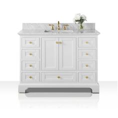 a white bathroom vanity with two gold faucets