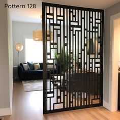 a room divider in the middle of a living room with a couch and table