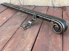 a metal object sitting on top of a wooden floor next to a brick wall and door