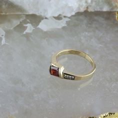 14K Yellow Gold Garnet and Diamond Ring, garnet rectangular offset 4 round diamond side stones, .25 inch across, Ring size 6.75, Circa 1970, 3.4 grams SKU # BB256R27 Most rings are sizable for a small fee. If the ring you are considering is the incorrect size contact us for a quote. This listing contains photographs of the actual item you will receive. Our items are in excellent condition with little or no signs of wear and many are one of a kind pre-owned estate finds. Please look closely at th Garnet And Diamond Ring, Round Diamond, Round Diamonds, Garnet, Diamond Ring, Ring Size, Silver Rings, Yellow Gold, Size 6