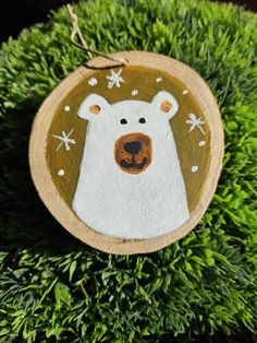 a wooden ornament with a polar bear on it