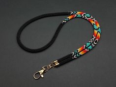 Native style bead lanyard with intricate patterns, perfect as a stylish badge holder for work or events. Handcrafted and durable, it adds a unique touch to any outfit. **Style and Personality in One Accessory**   - Add a vibrant touch to your daily routine with this colorful beaded lanyard.   - The multicolor design enhances your unique style, making it a standout piece.   - Perfect for office wear, conferences, or everyday badge use.   **Lightweight and Comfortable for Daily Wear**   - Enjoy al Seed Bead Lanyard, Bead Lanyard, Bead Loom Designs, Beaded Lanyard, Wrist Lanyard, Teacher Lanyard, Key Lanyard, Beaded Lanyards, Native Style