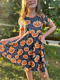 **Ready to Ship** Halloween Jack O' Lantern Twirl Dress for Girls - Sizes 12M to 10 Get your little one ready for a spook-tacular Halloween with our adorable Jack O' Lantern Twirl Dress! Perfect for Halloween parties, trick-or-treating, or festive fall gatherings, this charming dress features a playful jack-o'-lantern print that twirls beautifully with every spin. Available in sizes ranging from 12 months to girls' size 10, this dress is designed to ensure comfort and style for every Halloween c Lantern Outfit, Bat Silhouette, Festive Dress, Portrait Dress, Ruffle Leggings, Silhouette Dress, Jack O'lantern, Patch Dress, Outfit Halloween