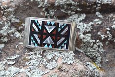 A beautifully crafted sterling silver piece inlayed with Nevada Turquoise, Coral, Black Onyx and Shell centered on a sterling silver cuff. A great addition to any days wear. Artists; L. Othole. Zuni, NM. Handmade in the USA. Vintage. Southwestern Style Turquoise Cuff Bracelet With Inlay, Vintage Bangle Cuff Bracelet With Inlay, Southwestern Turquoise Cuff Bracelet With Inlay, Vintage Turquoise Bracelet With Inlay, Vintage Inlay Cuff Bracelet, Sterling Silver Cuff, Silver Pieces, Silver Cuff, Black Onyx