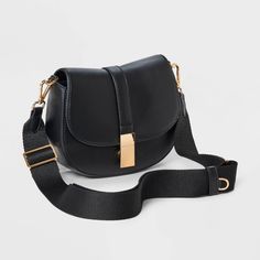 This Saddle Crossbody Bag from A New Day™ with a structured silhouette features a roomy main compartment and an interior zip pocket for easy organization of your belongings, plus an overlapping flap with a gold-tone buckle accent and magnetic closure. Plus, the detachable adjustable shoulder strap makes carrying a breeze whether you sling it over one shoulder or carry it in hand. A New Day™: Style that goes wherever you do. Gold Shoulder Bag With Adjustable Strap For Work, Modern Gold Flap Bag With Adjustable Strap, Crossbody Saddle Bag With Magnetic Closure For Work, Workwear Crossbody Saddle Bag With Magnetic Closure, Gold Satchel Shoulder Bag For Work, Gold Crossbody Bag For Work, Versatile Saddle Bag With Gold-tone Hardware For Travel, Versatile Travel Saddle Bag With Gold-tone Hardware, Gold Bags With Magnetic Closure For Work