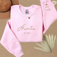 Are you looking for a meaningful gift for a special auntie in your life?  Look no further! Our "Auntie" sweatshirt is the ideal choice.  Made with premium quality fabric, this comfortable and stylish sweatshirt is perfect for any occasion, especially Mother's Day.  Capture the love between aunt and her nephews with our sweatshirt featuring the kids' names elegantly printed on the sleeve. It's a touching way to showcase her pride and joy. It is sure to bring a smile to her face. It's not just a sweatshirt; it's a symbol of love for being a aunt.  Surprise her with a personalized gift that celebrates the unique bond she shares with her nephews.  Order yours today and make this Mother's Day or another pleasant occasion extra special for the best aunt in your life! Auntie Sweatshirt, New Aunt, Best Aunt, Kids Names, Love Symbols, San Jose, Mother's Day Gifts, Sweat Shirt, Favorite Outfit