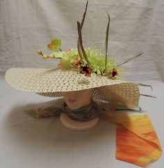 "Floppy Hat With Flowing hat band and Flowers / hippy / boho. This hat is adorned with a vintage scarf of orange yellow and green. It has light green Orchids and a large light green Dahlia, nestled by tiny orange flowers and spike like leaves of green and brown. Dimensions are approx. 22\" across and head size is approx. 7 1/2\". A great hat for that fresh new outfit." Green Dahlia, Green Orchid, Star Shoes, Vintage Scarf, Yellow And Green, Hat Band, Orange Flowers, 2 A, Orange Yellow