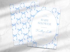 a blue and white baby shower card on a marble surface