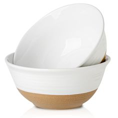 three white bowls stacked on top of each other with brown rims and one empty bowl in the middle