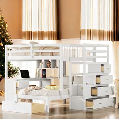 a white bunk bed sitting next to a christmas tree