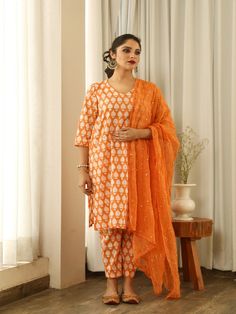 Beautiful handcrafted straight kurta pants set in pure cotton with lovely matching cotton doriya dupatta that is rightly finished with mirror embroidery. Color: Orange Fabric: Cotton and Kota Doria Note: Length and sizes can be customised Length - Kurta 40 inches Pants 38 inches Available in other colors If you happen to see some deformity in hand-work or fabric, that’s mere the technique of the same and not a defect. The garment is quite premium. The product will be delivered within 20-25 days