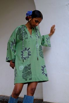 This mini dress is brought to life with our eclectic JODI hand block printed motifs. Crafted in cotton, it has a relaxed shape and a hood detail with checks. Look closely and you will see a cutesy bead hand embroidery detail too. We believe you have a right to know how this product was made. 3 meters of south Indian mangalgiri cotton fabric sourced from Jaipur has been used for this piece. Hand printed by our artisans in Jaipur, manufactured in our workshop at Pune, India. If you wish to have th Hand Printed Cotton Dresses, South Indian Fashion, Indian Print Dress, Wrap Waist Dress, Mens Outerwear Fashion, Dress Stands, Indian Prints, Indian Block Print, Hand Woven Textiles