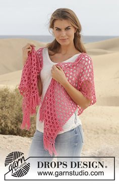 a woman wearing a pink crochet shawl in the desert