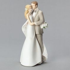 a figurine of a bride and groom holding each other