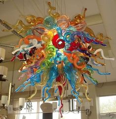 a multicolored glass chandelier hanging from the ceiling