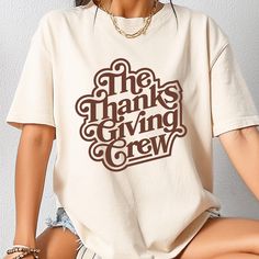 Celebrate the spirit of togetherness this Thanksgiving with our "Thanksgiving Crew" T-shirt! Perfect for family gatherings and turkey day festivities, this shirt embodies the joy of being surrounded by loved ones. Whether you're cooking in the kitchen, watching the parade, or enjoying a hearty feast, this tee is a great way to show your pride in being part of the Thanksgiving crew. Soft and comfortable fabric for all-day wear, keeping you cozy during your holiday celebrations. Bold, eye-catching design that brings a sense of unity and fun to your Thanksgiving festivities. Ideal for matching family shirts, holiday photos, or as a thoughtful gift for family members. Available in multiple sizes and colors to fit everyone in your crew! Wear this shirt with pride and let everyone know that you' Graphic Tee Crew Neck Tops For Family Gatherings, Graphic Tee With Crew Neck For Family Gatherings, Graphic Cotton T-shirt For Family Gatherings, Family Matching Graphic Print T-shirt For Gatherings, Family Matching Graphic T-shirt, Crew Neck Cotton T-shirt For Family Gatherings, Cotton Crew Neck T-shirt For Family Gatherings, Cotton Graphic Print T-shirt For Family Gatherings, Family Gathering Graphic Print Crew Neck T-shirt