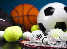 tennis balls, racquets and other sports related items are on the table