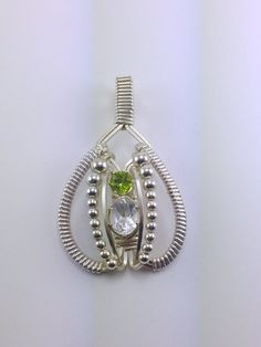 Wire Wrapped Pendant White Topaz Peridot by RyanEure on Etsy Oval Multi-stone Peridot Gemstones, Unique Oval Birthstone Gemstones, Silver Teardrop White Topaz Jewelry, Silver Peridot Oval Jewelry, Oval Peridot Silver Jewelry, Silver Oval Peridot Jewelry, Silver Green Amethyst Gemstones For Gift, Oval Peridot Multi-stone Jewelry, Oval Silver May Birthstone Gemstones