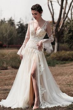 Vintage-inspired and romantic, this boho wedding dress features an eye-catching illusion bodice with bell sleeves, delicate deep V-neckline adorned with dot lace trim, a flattering back with button closure, and fine floral lace cascading down to fit and flare skirt with high slit. #weddingdress #bridaldress #designerweddingdress #springweddingdress #fallweddingdress #winterweddingdress #summerweddingdress #bohoweddingdress #beachweddingdress #destinationweddingdress Wedding Gown Bell Sleeves, Nude Wedding Dress, Beige Wedding Dress, Puff Sleeve Wedding Dress, Party Dress Inspiration, Beige Wedding, Spring Wedding Dress, Designer Bridesmaid Dresses, Destination Wedding Dress