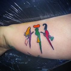 a woman's arm with colorful tattoos on it