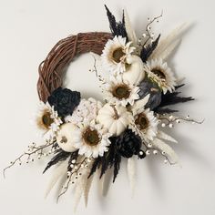 a wreath with white and black flowers on it