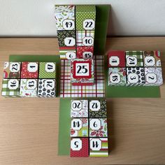 four blocks with numbers on them sitting on top of a table