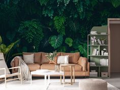 a living room filled with furniture and lots of greenery on the wall behind it