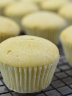 several yellow cupcakes cooling on a wire rack