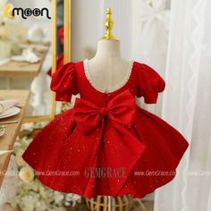 a red dress with a big bow on it