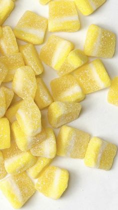 there are many pieces of yellow candy on the table