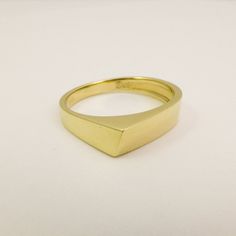 14K / 18K Solid Gold Geometric Ring for Men and Women, Wide Triangle Wedding Band Ring made of Yellow, White or Rose Gold. This ring is not symmetric in any way, the sides of the ring have different widths and it performs an interesting game of angles and geometric shapes. Wide, modern and bold design that was made to be playful and fun to wear. Strong and boldly shaped as a tiny gold sculpture, would make a great alternative wedding ring. Allowing many stacking options with other geometric desi Modern Gold Signet Promise Ring, Modern 14k Gold Signet Ring For Wedding, Minimalist 14k Stamped Rings For Formal Occasions, Minimalist Yellow Gold Promise Signet Ring, Modern Gold Signet Ring For Wedding, Modern Gold Couple Rings For Formal Occasions, Modern Gold Wedding Signet Ring, 14k Yellow Gold Signet Promise Ring, Minimalist 14k Gold Couple Rings For Formal Occasions