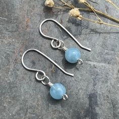 * Genuine aquamarine stones  * Little drop earrings * All parts Sterling silver  * March birthstone  Perfect for a March birthday gift but lovely for anyone who loves aquamarine  If you would like these earrings on hooks, marquis ear wires, lever backs, studs, different type of hoops please ask I have and make all types! Can be sent with a handmade, hand written gift card and will be beautifully packaged as a gift  Please see my other genuine gemstone and silver jewellery - all hand made, in my shop: RedDollyDesigns.Etsy.com Light Blue Aquamarine Birthstone Jewelry, Aquamarine Earrings Gift, Silver Aquamarine Gemstone Earrings, Silver Aquamarine Round Earrings, Handmade Light Blue Aquamarine Jewelry, Light Blue Aquamarine Drop Earrings, Nickel-free Blue Aquamarine Jewelry, Dainty Blue Birthstone Earrings, Minimalist Blue Birthstone Earrings