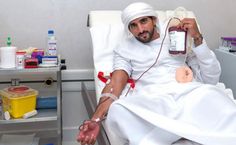 a man sitting in a hospital bed holding a bottle