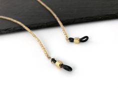 This crystal gold lined eyeglasss holder necklaces are made of Czech Fire Polished beads. It goes well with all your reading glasses and gives you a perfect elegant look, an ideal gift for women. EC019 * Quantity: 1pc * Materials: - 4mm Czech Fire Polished Crystal Gold Lined - Rubber connector * Measurement: Total length 75cm(29.5inch) including adjustable rubber end connectors * Metal Color: Gold * No return or refund for this made to order item. For more eyeglass chains, please visit this link Glass Necklaces With Gold Chain For Gift, Gold Glass Necklace With Adjustable Chain, Elegant Gold Glasses Chain With Beaded Detail, Elegant Gold Beaded Glasses Chain, Gold Chain Glasses Chains Made Of Glass For Gift, Adjustable Gold Glass Chain For Glasses, Gold Chain Glasses Chains For Gifts, Gold Chain Glasses Chain As Gift, Adjustable Gold Beaded Necklace With Chain