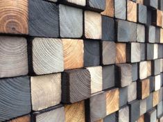 wood planks stacked on top of each other with different colors and shapes in them