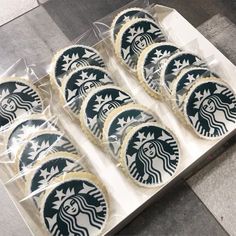 six starbucks cookies are in a box on the floor with white frosting and black stars