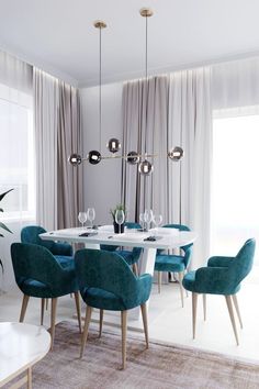 a dining room with blue chairs and a white table