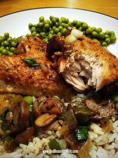 a white plate topped with rice and meat covered in mushrooms, green beans and peas