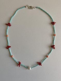 This delicate piece is an elevated version of your your typical Y2K beaded necklace. Made with Italian corral, glass beads, and freshwater pearl. 925 silver finishes. 18 inches in length. Coral Beaded Necklace With Tiny Beads As Gift, Coral Beaded Pearl Necklace As Gift, Gift Coral Beaded Pearl Necklace, Coral Beaded Necklaces With Colorful Beads For Gifts, Coral Beaded Necklaces For Gift, Coral Beaded Necklace As Gift, Coral Colorful Beaded Necklaces As Gift, Coral Beaded Chain Necklace As A Gift, Coral Beaded Chain Necklace For Gift