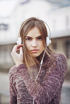 a woman with headphones on her ears