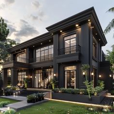 a large black house with lots of windows and lights on the front porch, surrounded by greenery