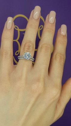 a woman's hand with a diamond ring on it