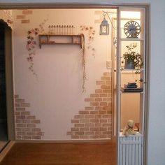 a room with a brick wall and shelves on the wall, including a radiator